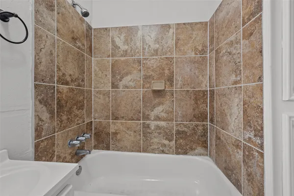 a bathroom with a bathtub and shower