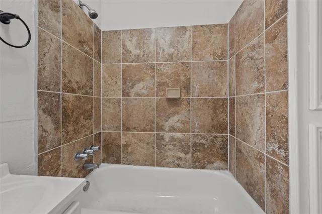 a bathroom with a bathtub and shower