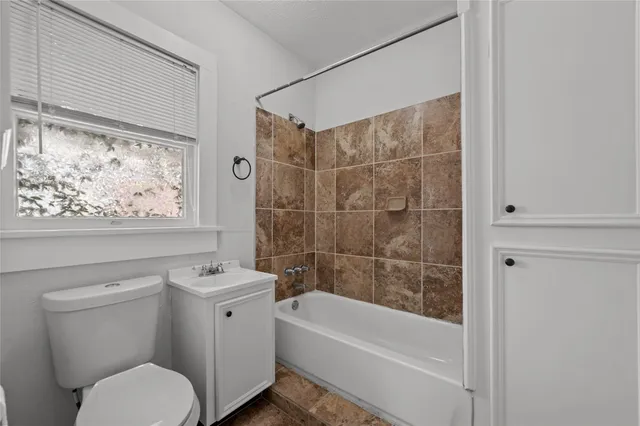 a bathroom with a toilet a sink and bathtub