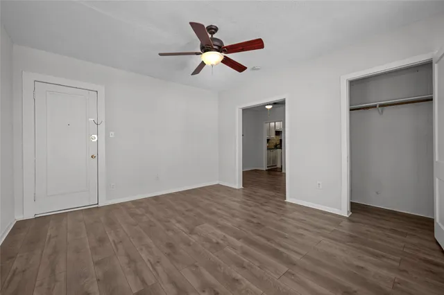 a view of an empty room and wooden floor