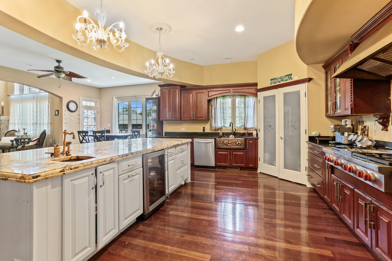 54 Sawgrass Drive Lemont, IL 60439 - Photo 11 of 41 a large kitchen with stainless steel appliances granite countertop a stove top oven a sink dishwasher a dining table and chairs with wooden floor