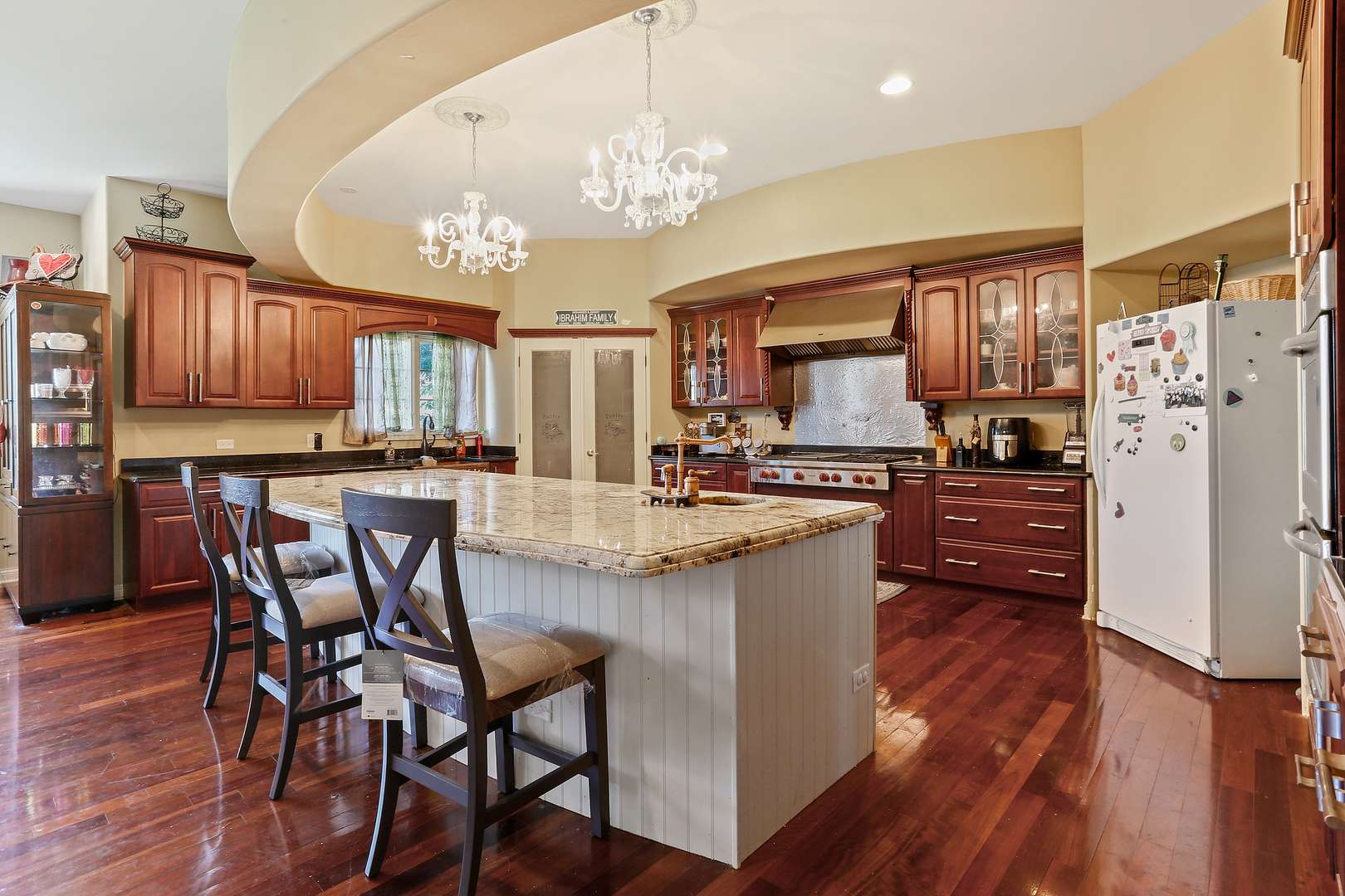 54 Sawgrass Drive Lemont, IL 60439 - Photo 10 of 41 a kitchen with stainless steel appliances granite countertop a stove a refrigerator a oven a sink a dining table and chairs with wooden floor