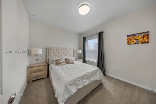 a bedroom with a bed and a lamp