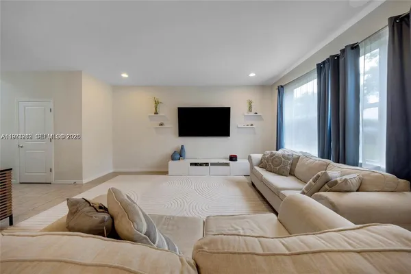 a living room with furniture and a flat screen tv