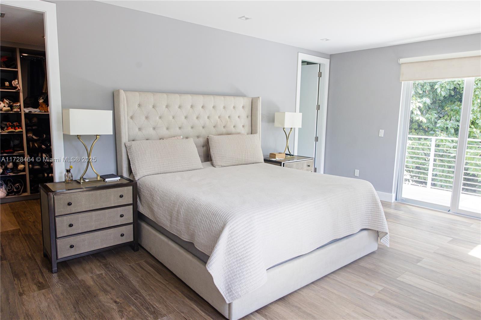 6790 Southwest 72nd Street South Miami, FL 33143 - Photo 11 of 34 a large bed sitting in a bedroom next to a window