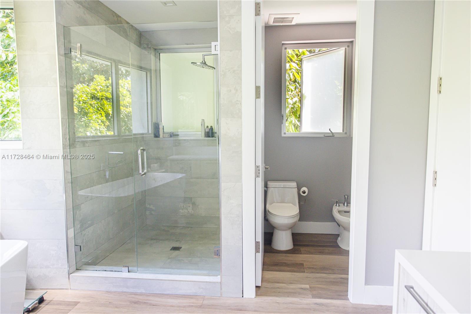 6790 Southwest 72nd Street South Miami, FL 33143 - Photo 12 of 34 a bathroom with a shower and toilet