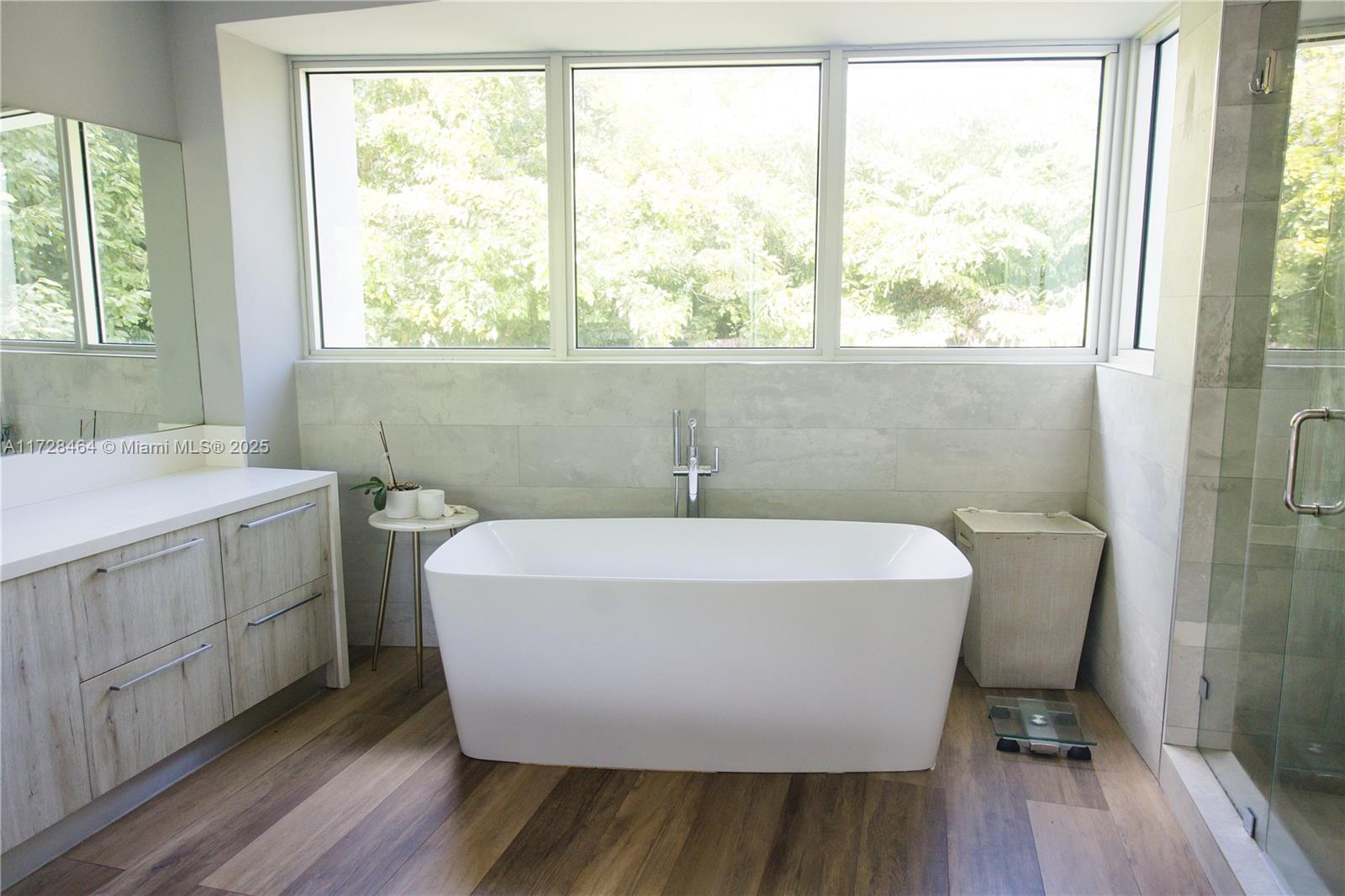 6790 Southwest 72nd Street South Miami, FL 33143 - Photo 15 of 34 a white bath tub sitting in a bathroom next to a window