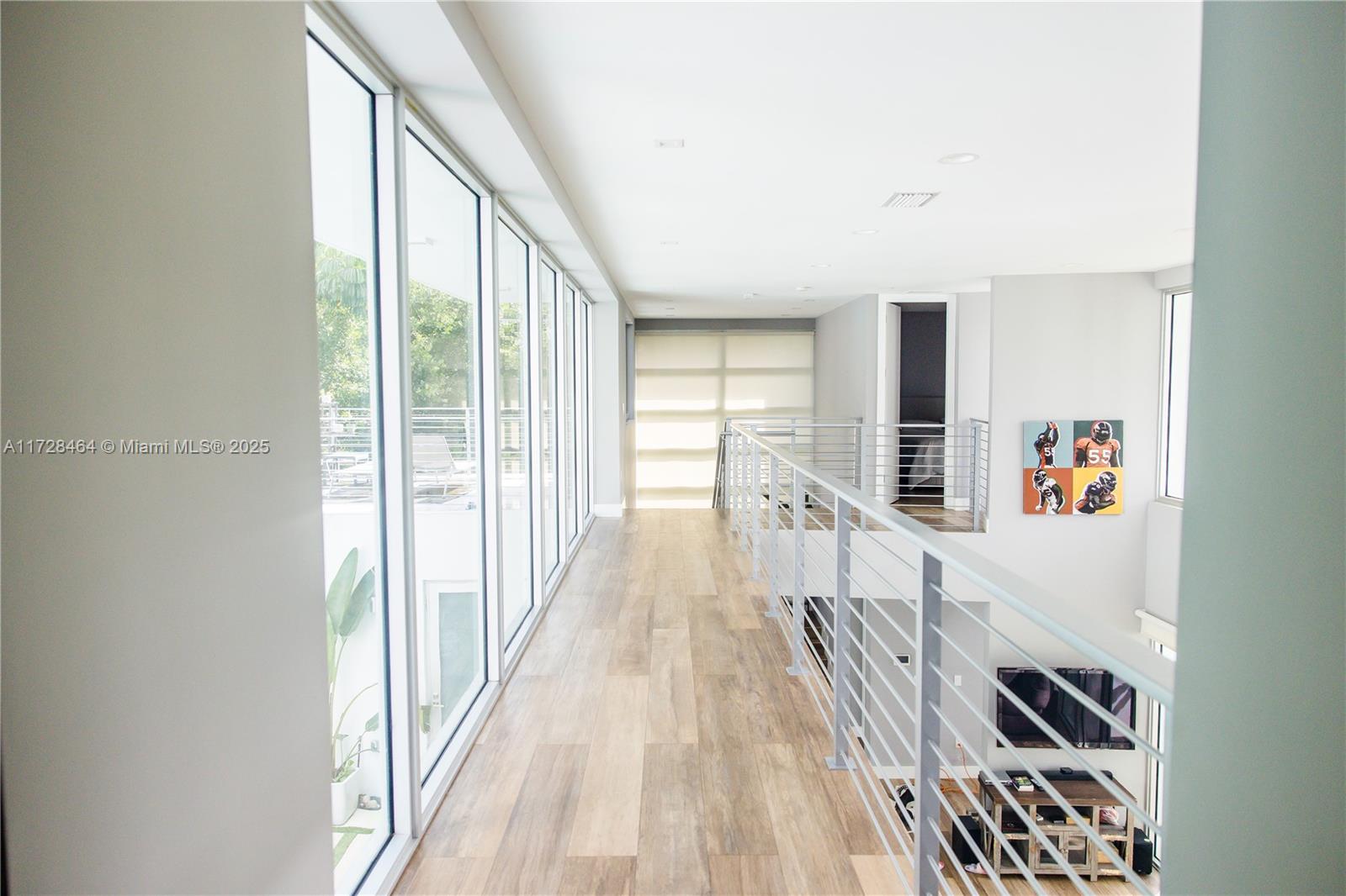 6790 Southwest 72nd Street South Miami, FL 33143 - Photo 19 of 34 a view of a hallway with wooden floor and furniture