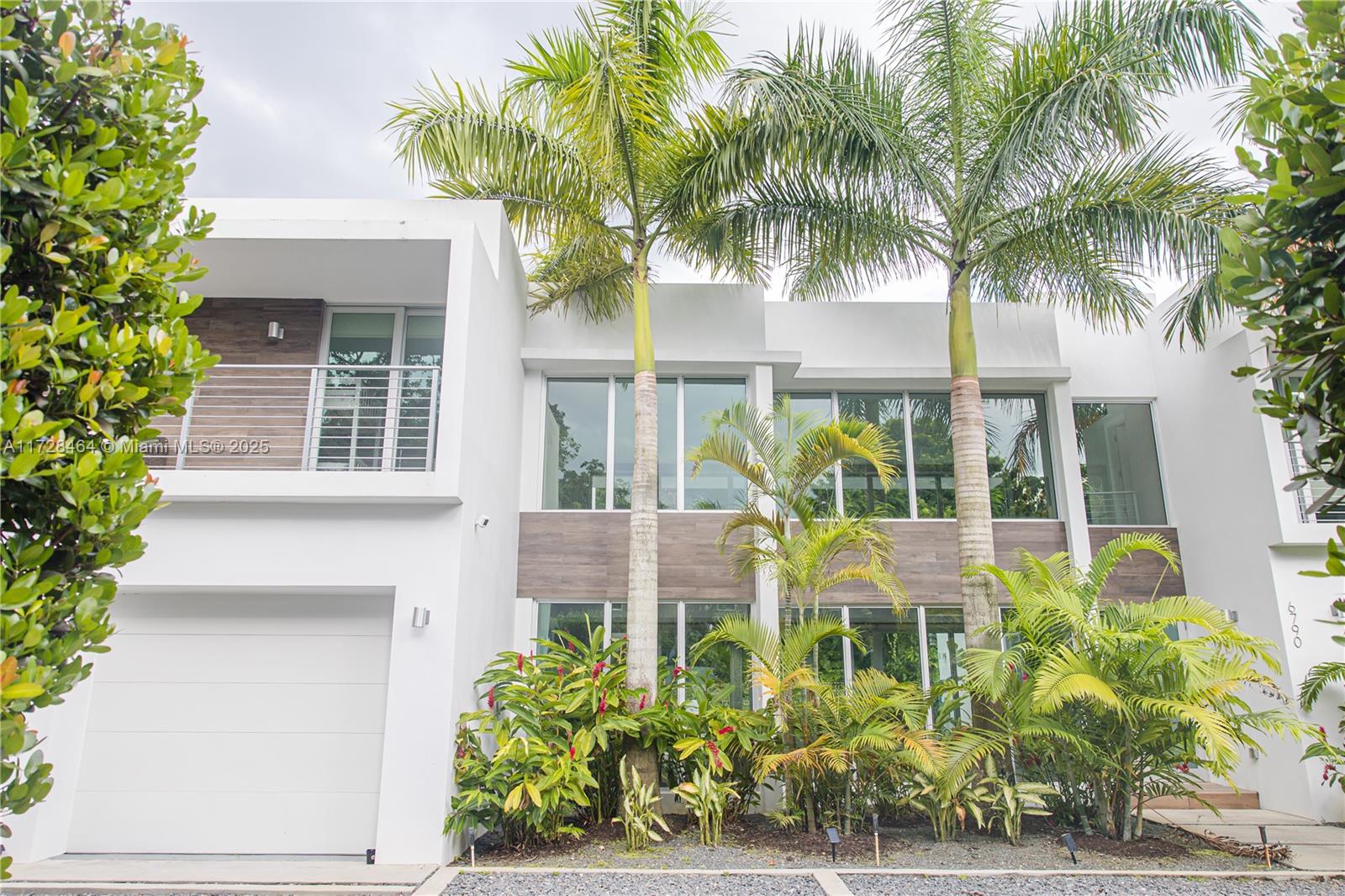6790 Southwest 72nd Street South Miami, FL 33143 - Photo 34 of 34 a front view of a house with balcony and garden