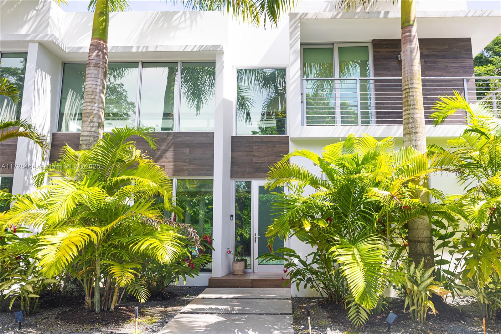 6790 Southwest 72nd Street South Miami, FL 33143 - Photo 7 of 34 a front view of a house with a garden