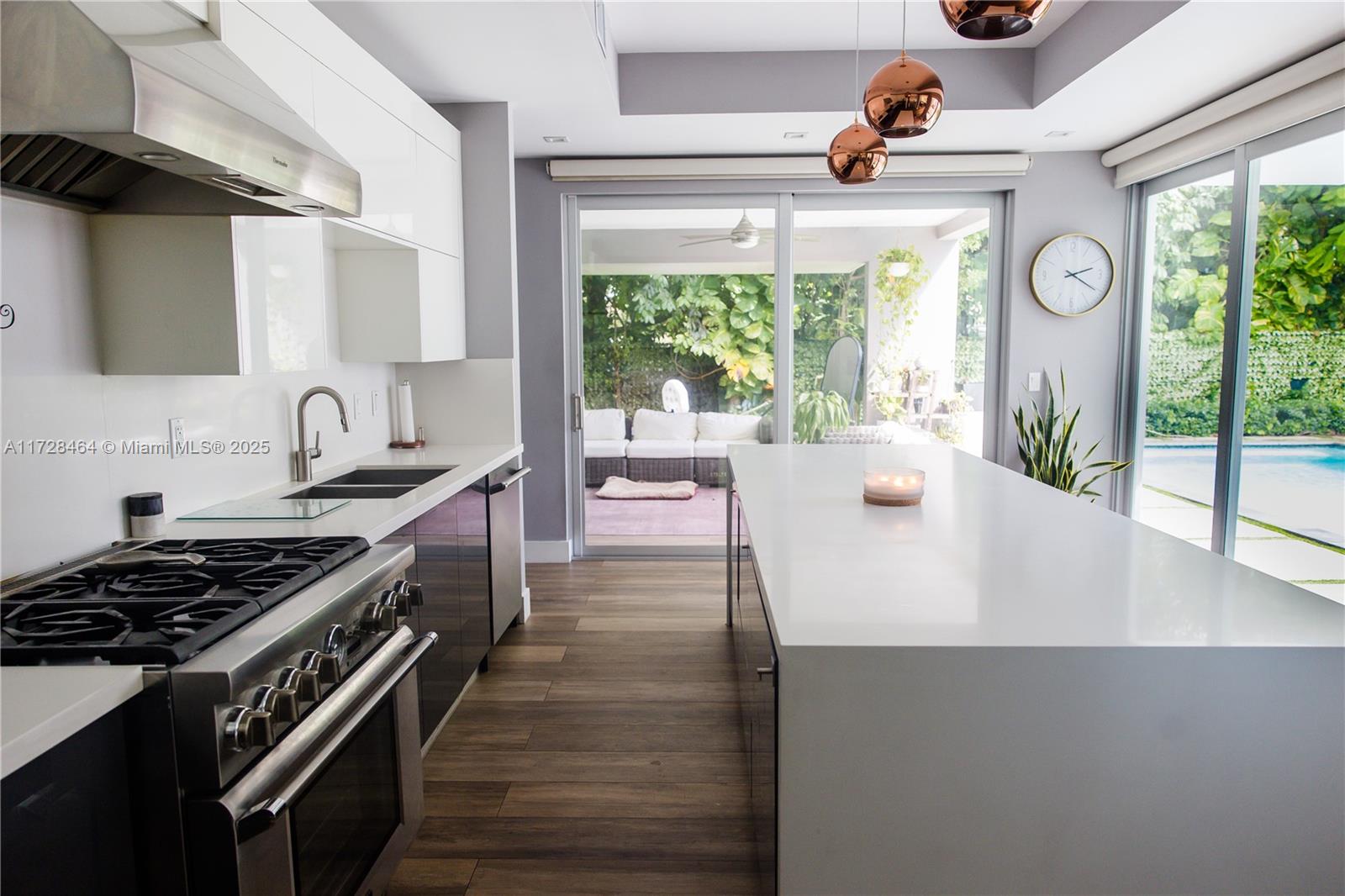 6790 Southwest 72nd Street South Miami, FL 33143 - Photo 9 of 34 a kitchen with stainless steel appliances a sink a stove and a window