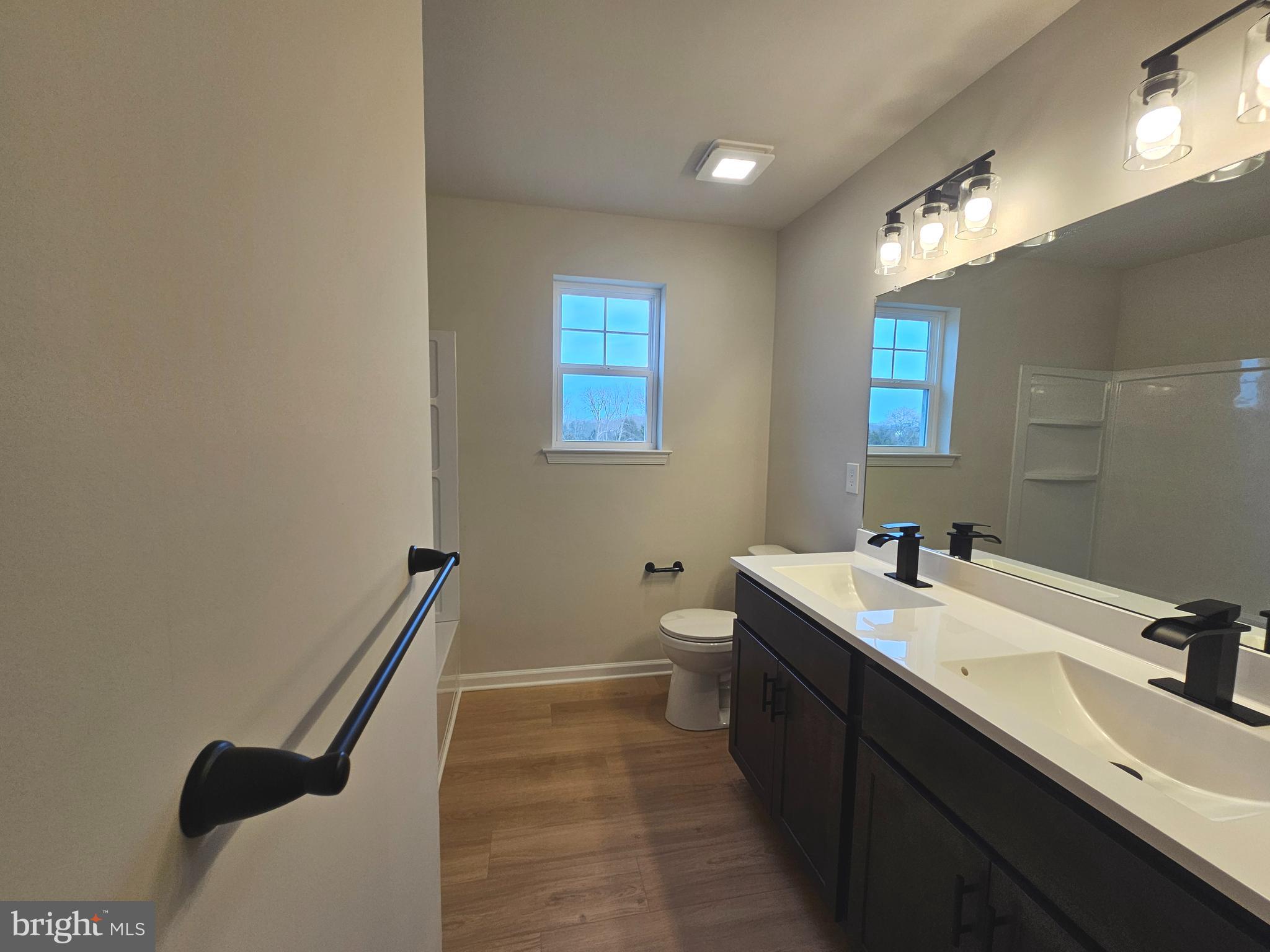 16 Field Stone Court Bridgeton, NJ 08302 - Photo 16 of 20 a bathroom with a sink a toilet a mirror and a bathtub