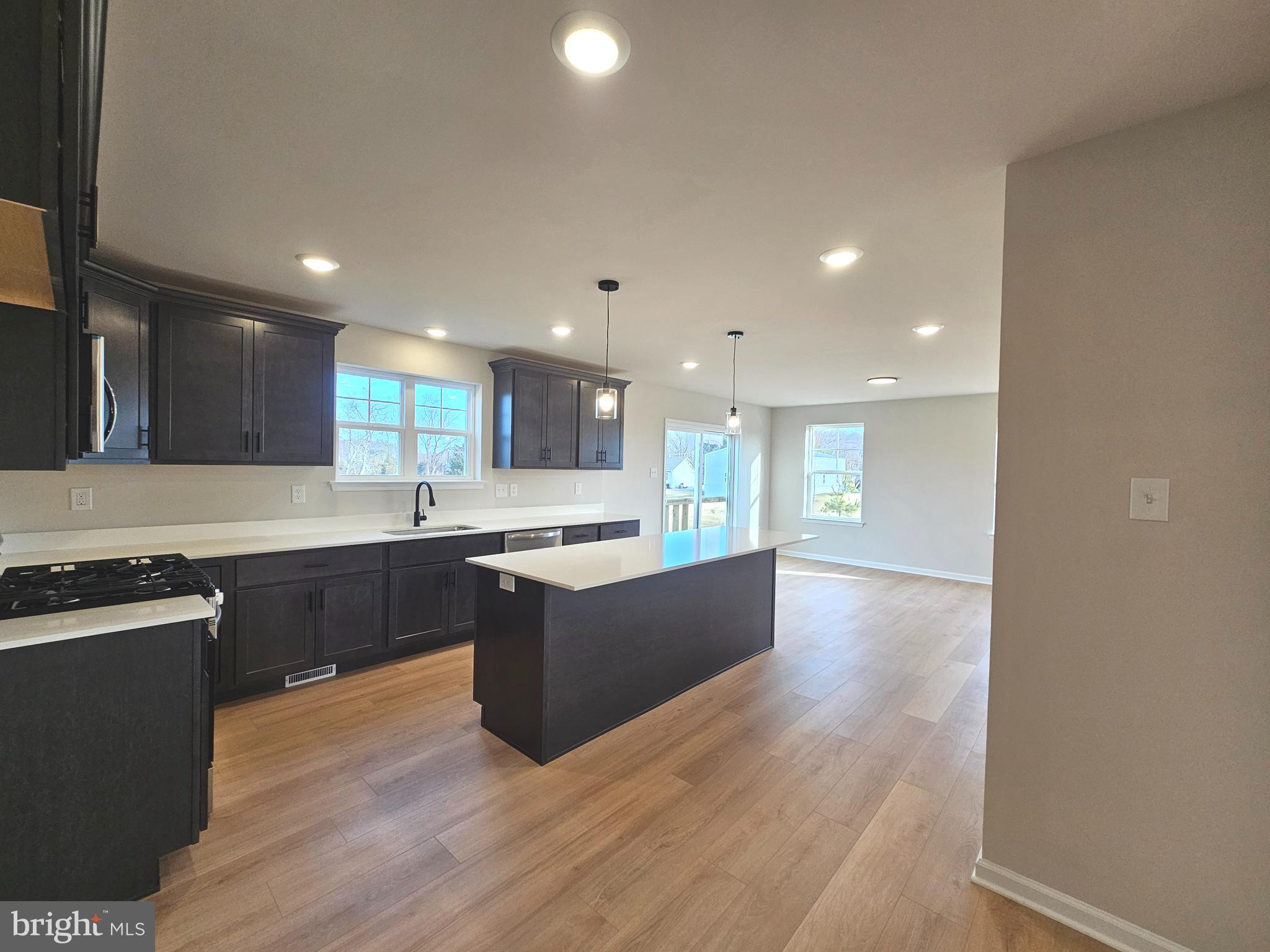 16 Field Stone Court Bridgeton, NJ 08302 - Photo 3 of 20 a large kitchen with stainless steel appliances granite countertop a large counter top and wooden floors
