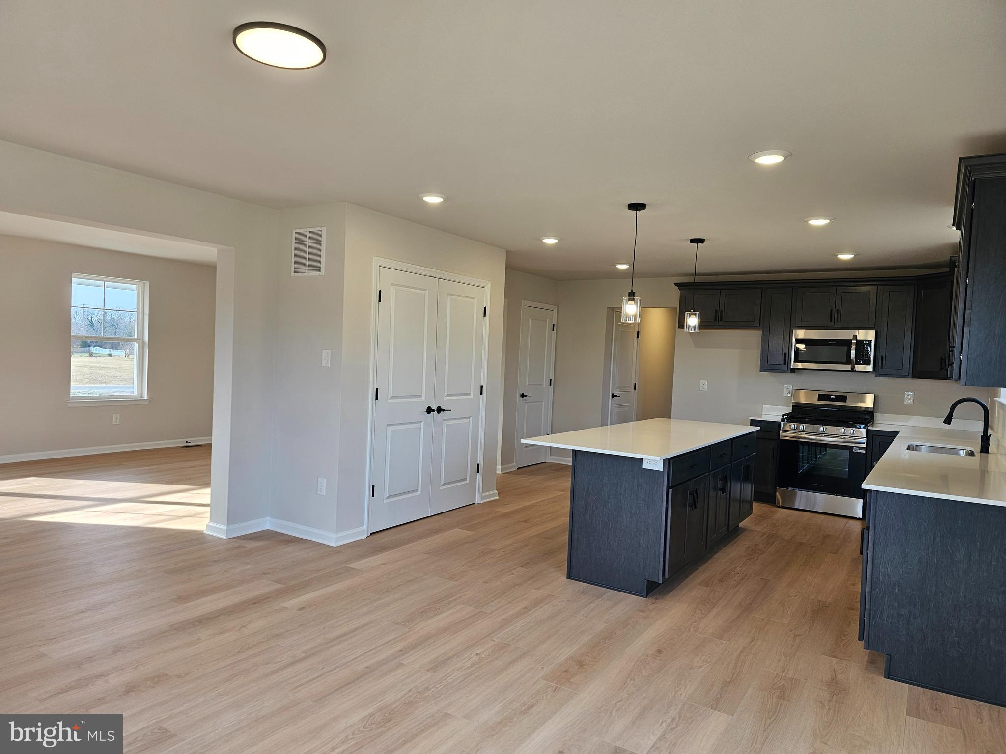 16 Field Stone Court Bridgeton, NJ 08302 - Photo 4 of 20 a living room with wooden floor and kitchen view