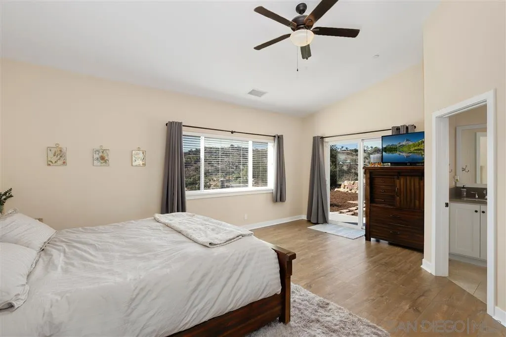 12972 Anthony Ridge Road Valley Center, CA 92082 - Photo 9 of 25 a bedroom with a large bed and a window