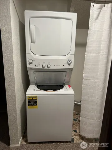 a bathroom with a granite countertop sink and a toilet