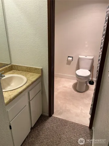 a view of empty room with a fireplace