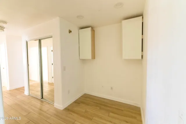 a view of a room with wooden floor