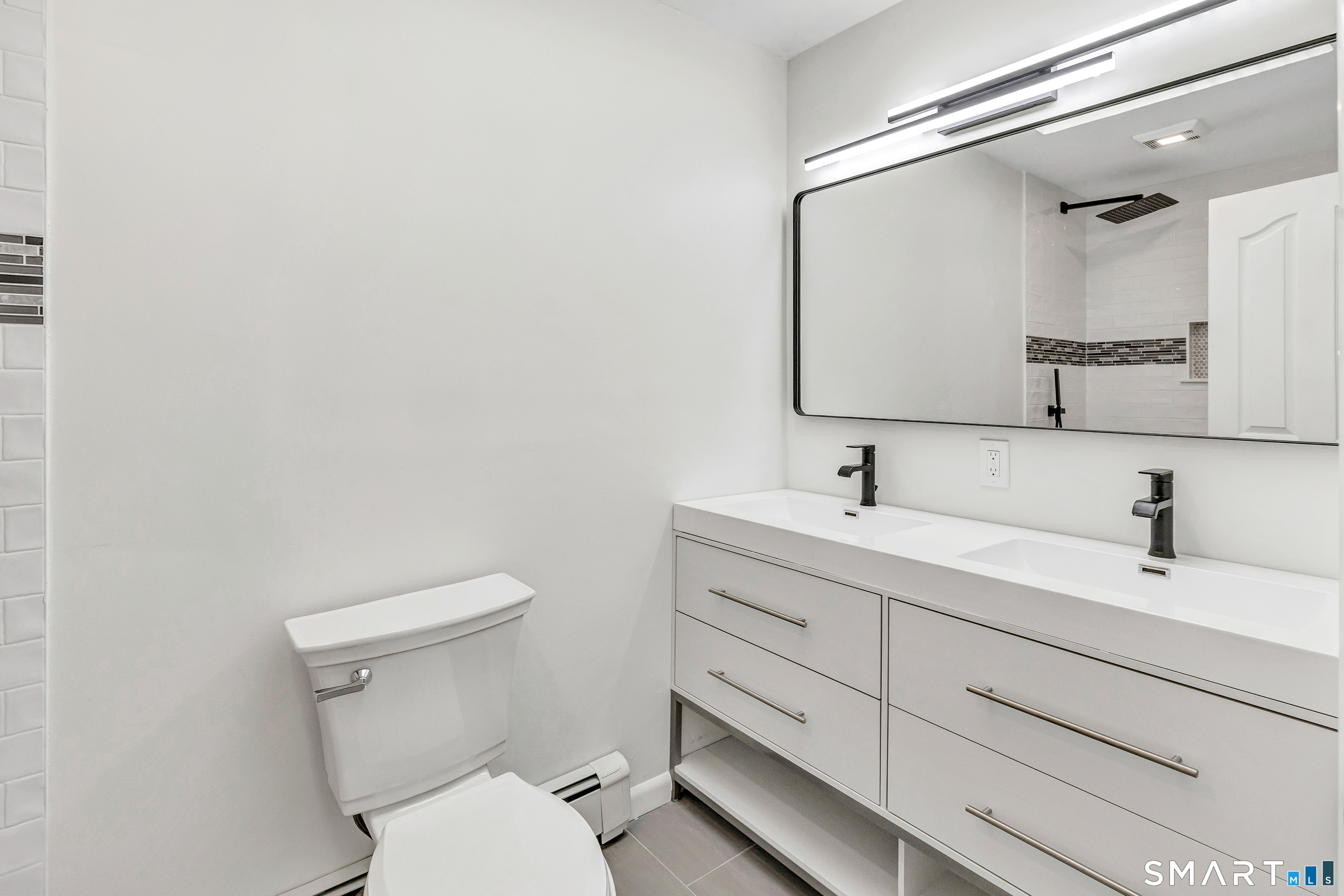 48 Crestwood Road Monroe, CT 06468 - Photo 24 of 32 a bathroom with a toilet sink and mirror