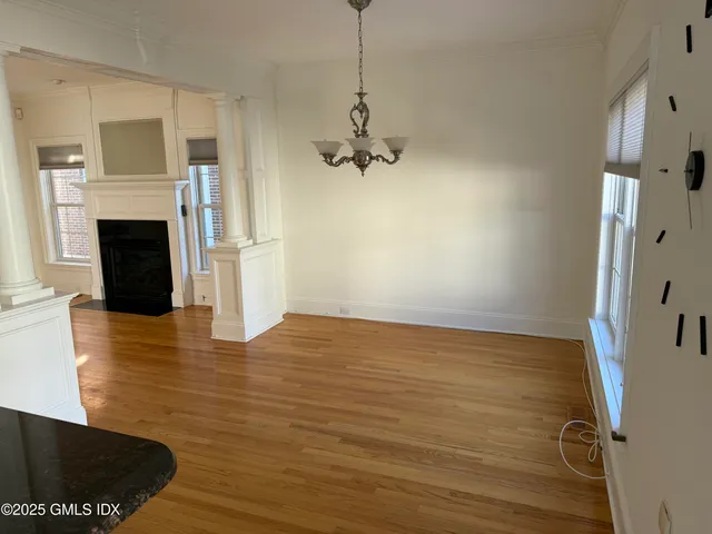 a view of a patio with table and chairs potted plants and a palm tree