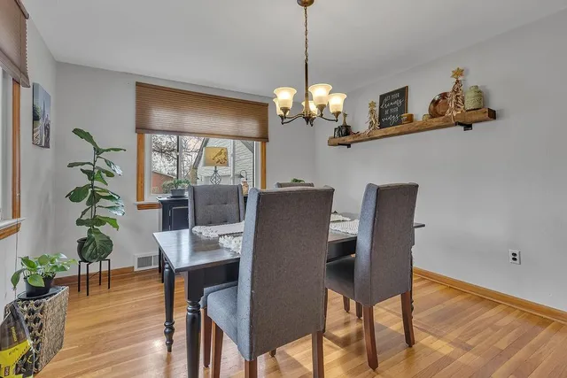a view of a dining room with furniture wooden floor and chandelier