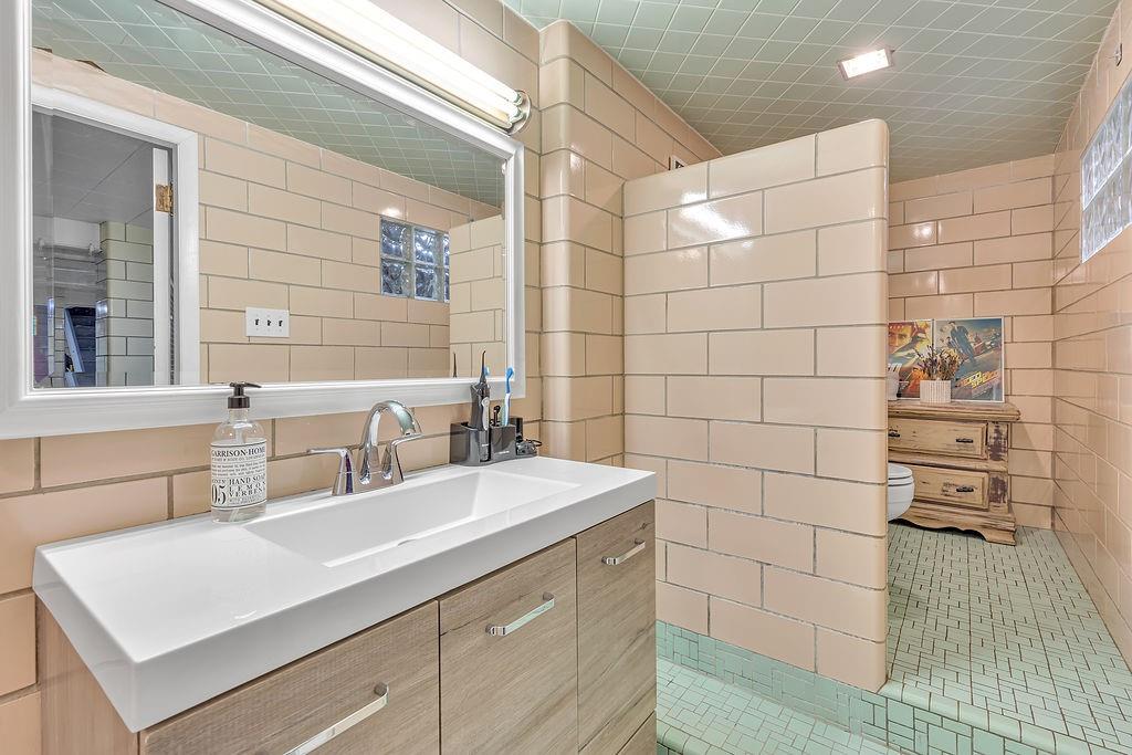 250 Neville Road Beaver, PA 15009 - Photo 25 of 36 a bathroom with a sink shower and a mirror