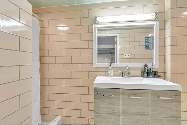 a bathroom with a double vanity sink and a mirror