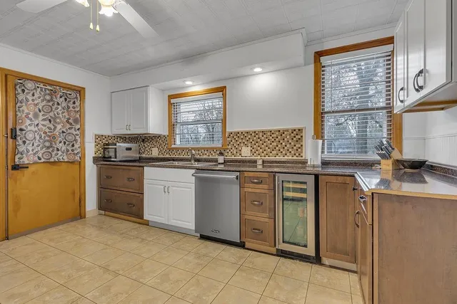 a kitchen with a stove sink and cabinets
