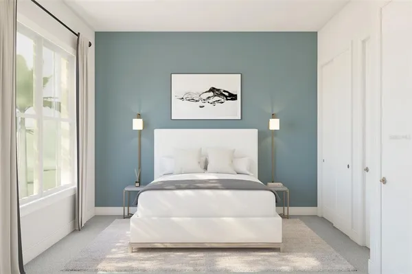 a bedroom with a large bed and a window