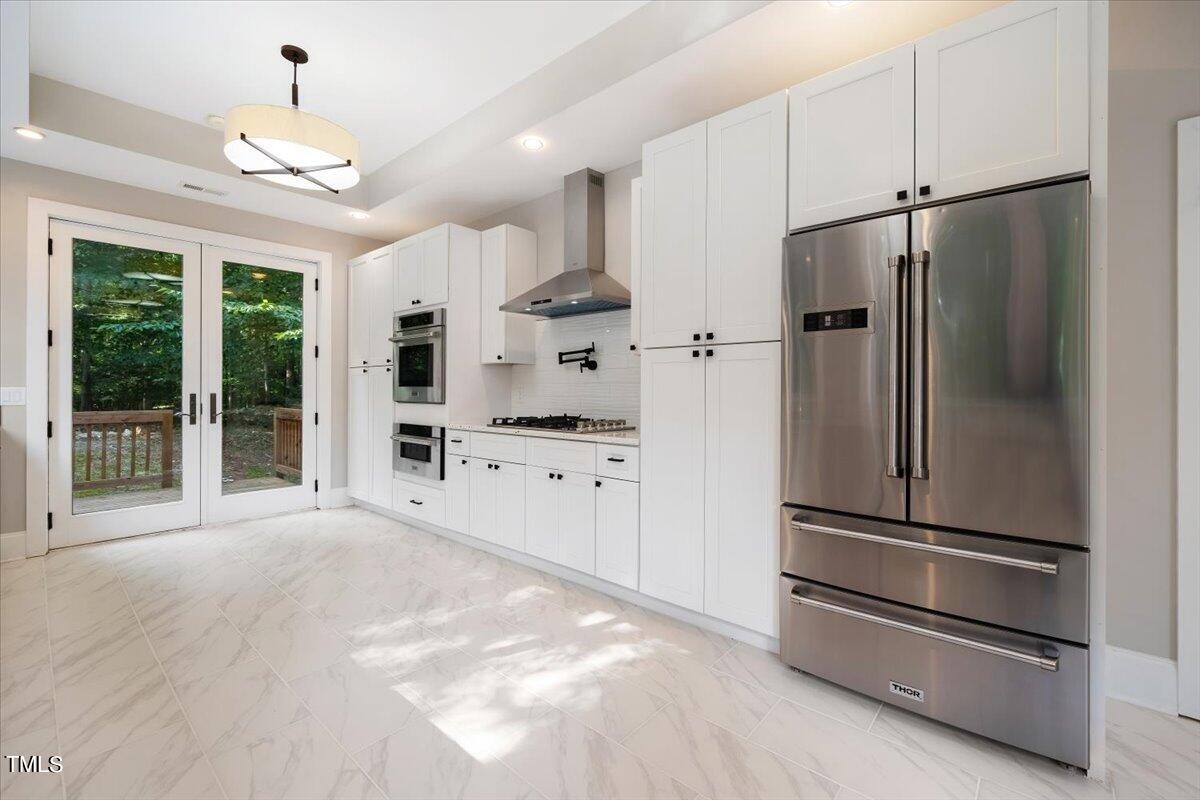 6300 Swallow Cove Lane Raleigh, NC 27614 - Photo 19 of 67 a kitchen with stainless steel appliances a refrigerator sink and cabinets