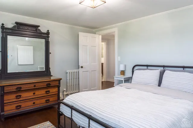 a bedroom with a bed and a dresser