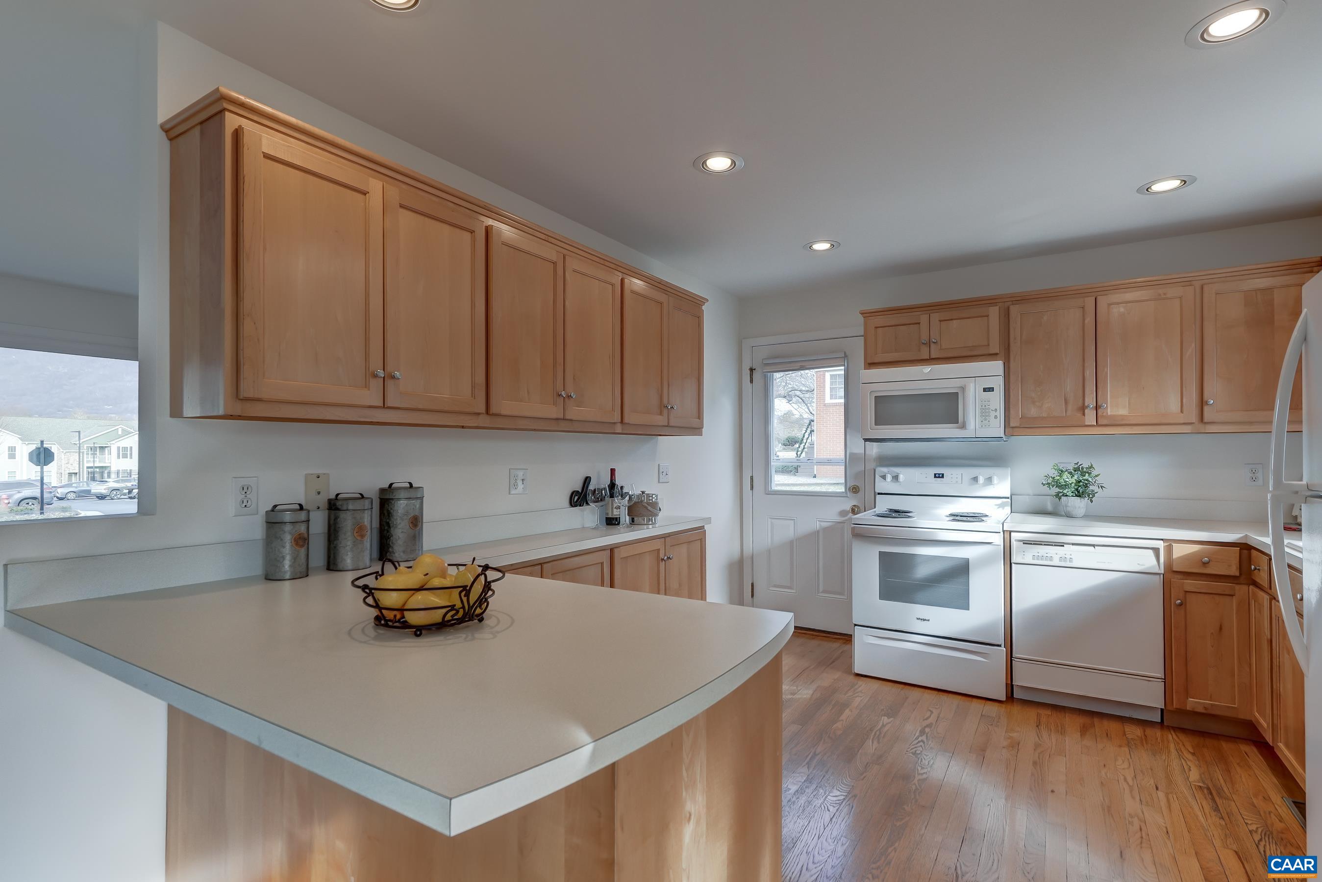 1179 Blue Ridge Avenue Crozet, VA 22932 - Photo 13 of 43 a kitchen with stainless steel appliances granite countertop a sink dishwasher stove and white cabinets with wooden floor
