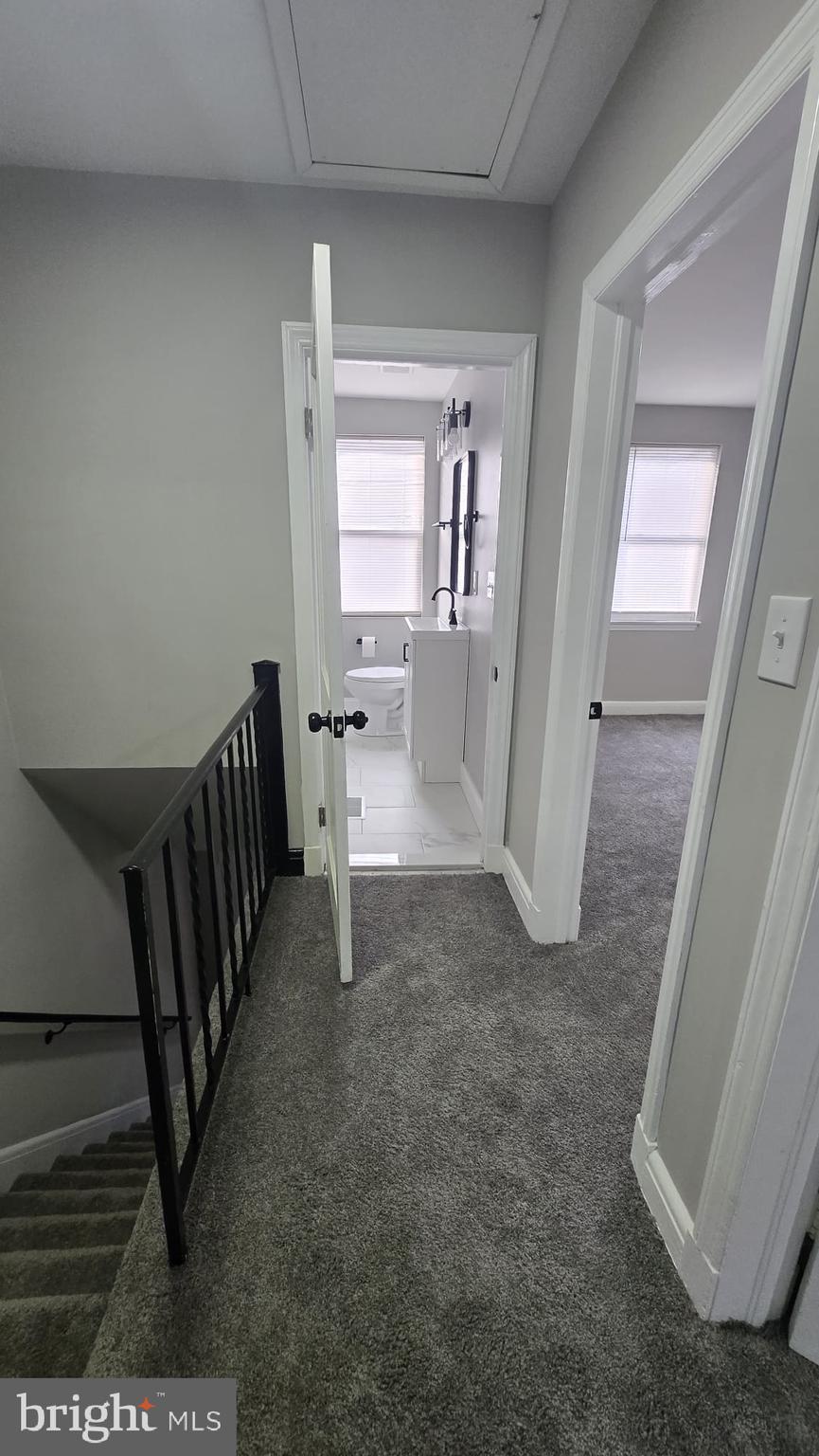 8623 Willow Oak Road Parkville, MD 21234 - Photo 11 of 27 a view of a hallway with wooden floor and stairs