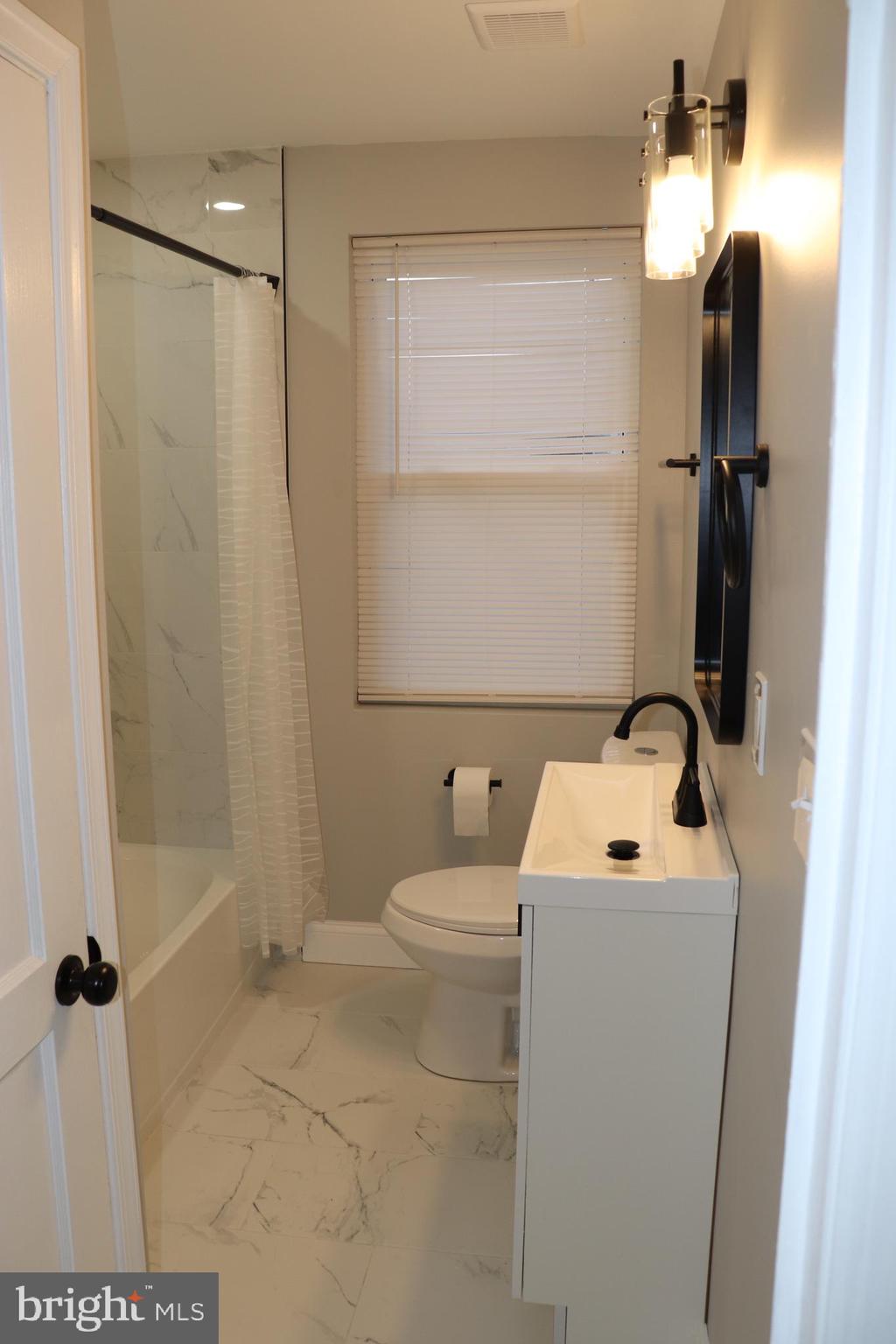 8623 Willow Oak Road Parkville, MD 21234 - Photo 12 of 27 a bathroom with a sink toilet and shower