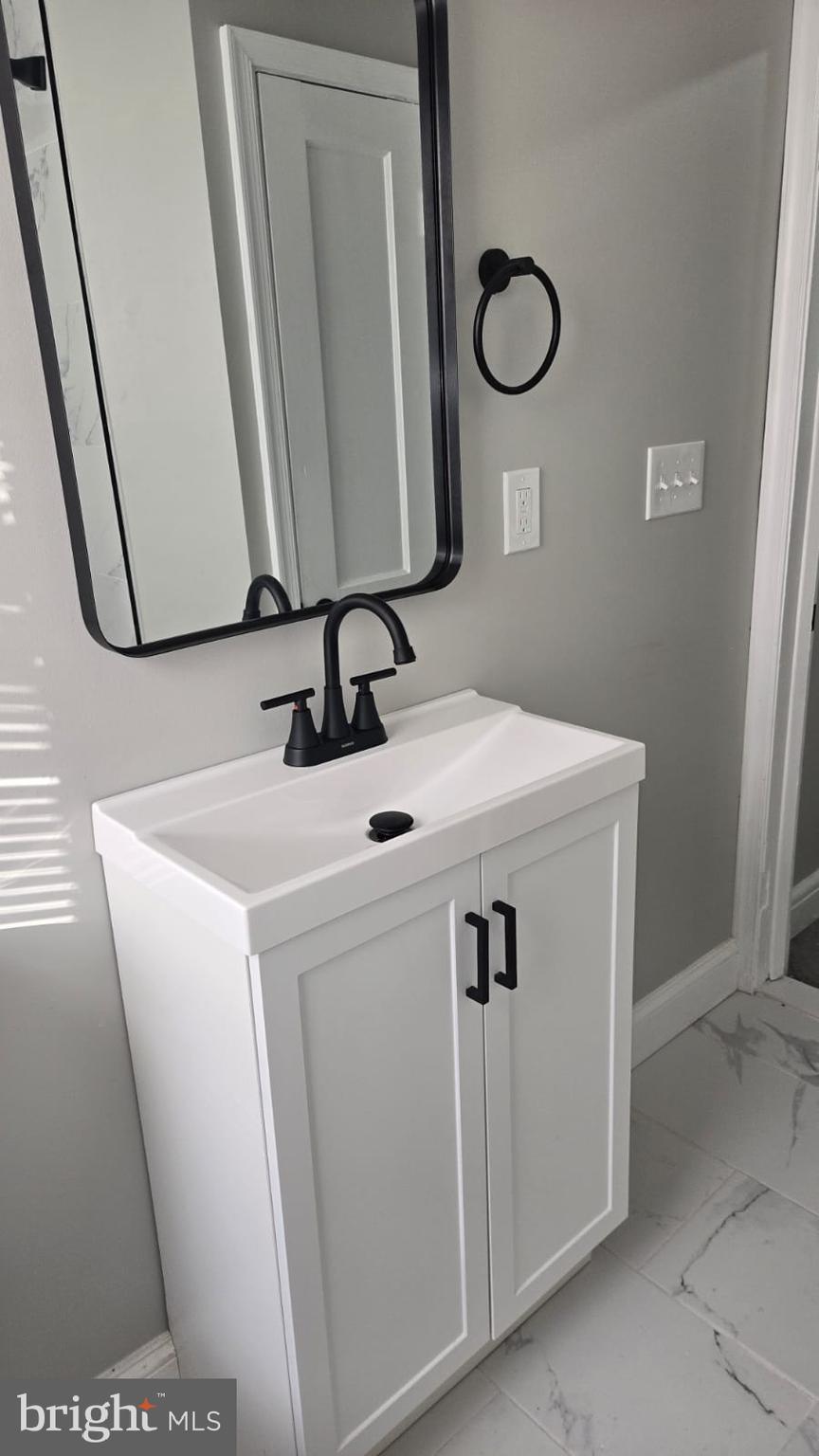 8623 Willow Oak Road Parkville, MD 21234 - Photo 14 of 27 a bathroom with a sink and a mirror