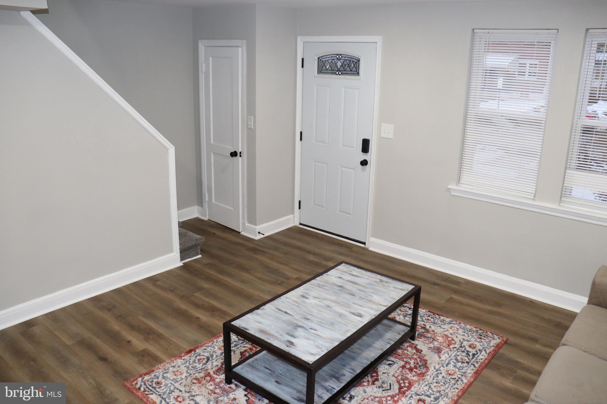 8623 Willow Oak Road Parkville, MD 21234 - Photo 2 of 27 an empty room with wooden floor and window
