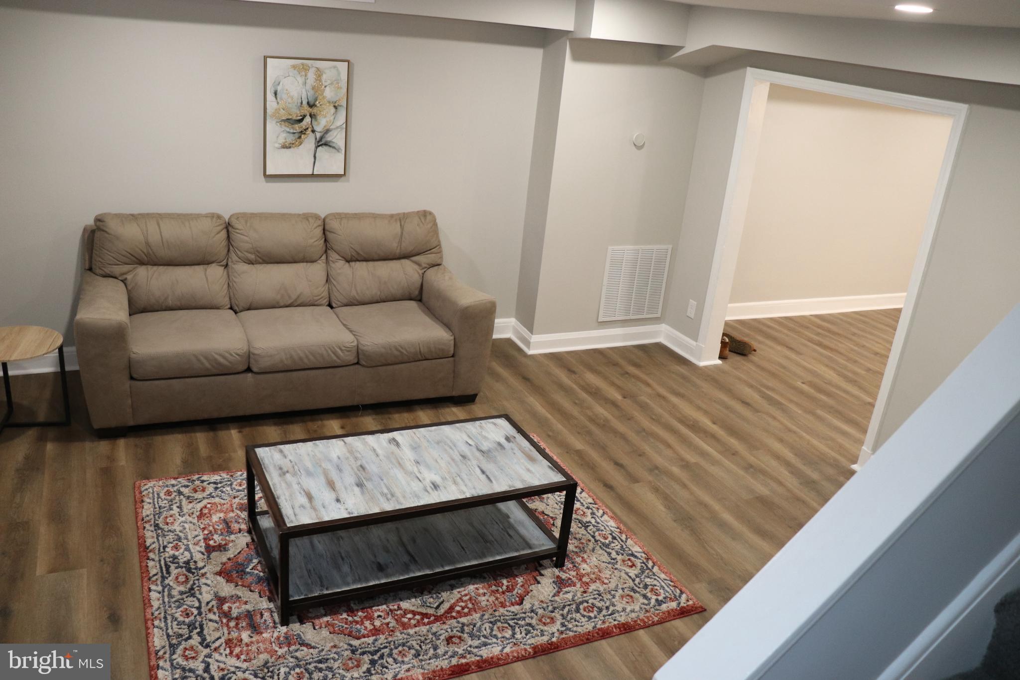 8623 Willow Oak Road Parkville, MD 21234 - Photo 3 of 27 a living room with furniture and a rug