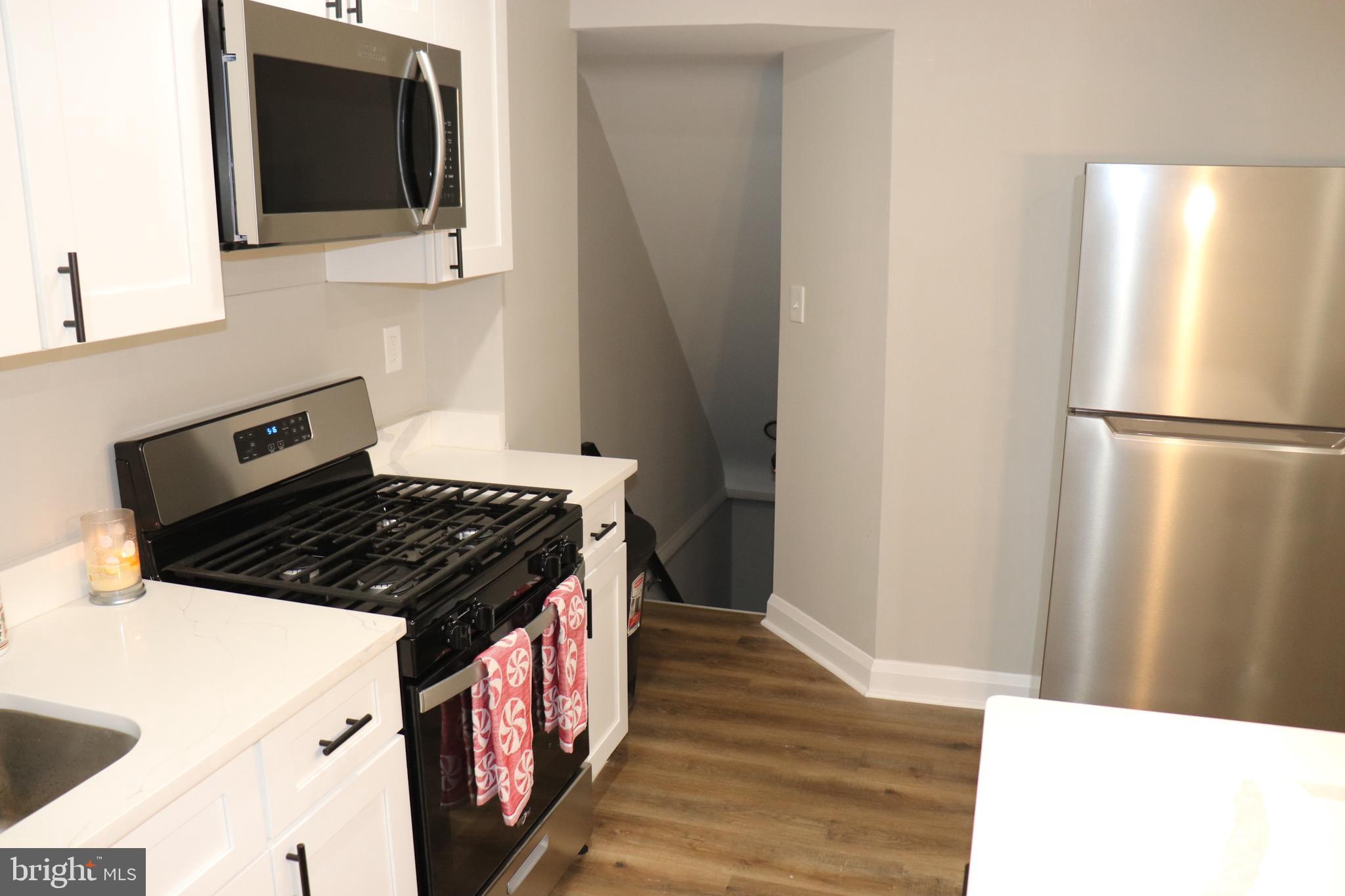 8623 Willow Oak Road Parkville, MD 21234 - Photo 6 of 27 a kitchen with a stove microwave and refrigerator