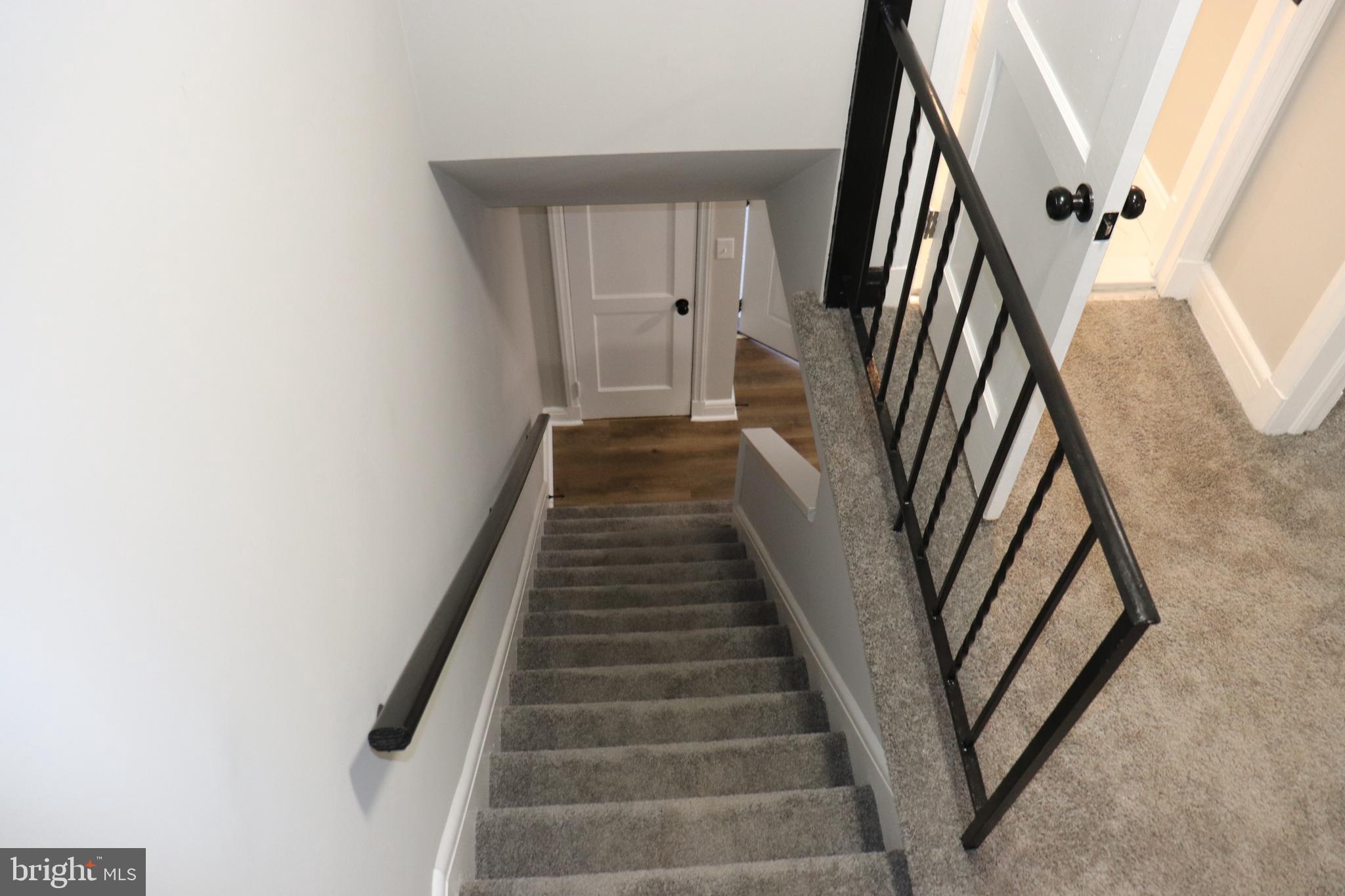8623 Willow Oak Road Parkville, MD 21234 - Photo 8 of 27 a view of staircase with wooden floor and white walls
