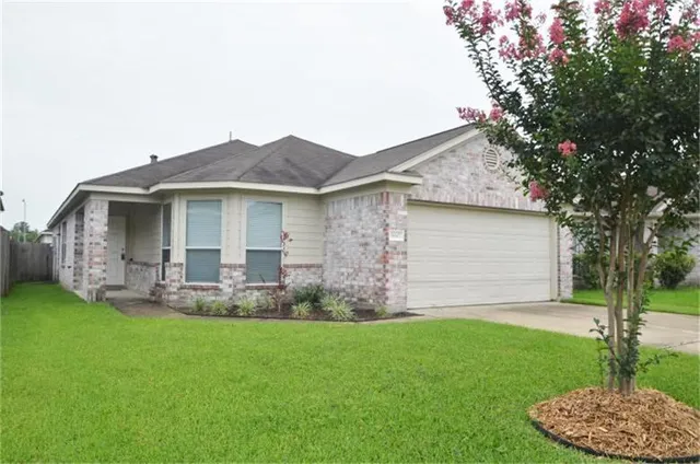 a view of a house with a yard and sitting area