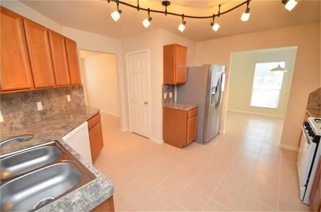 a kitchen with refrigerator and window