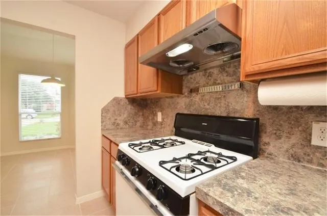 a stove top oven sitting inside of a kitchen