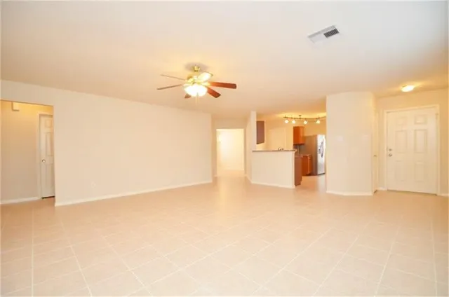 a view of an empty room with a kitchen