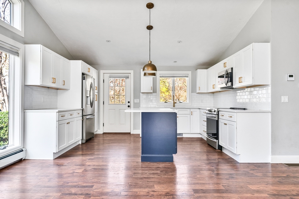 151 Wheeler Street Rehoboth, MA 02769 - Photo 11 of 36 a kitchen with stainless steel appliances granite countertop a refrigerator a stove a sink dishwasher and white cabinets with wooden floor