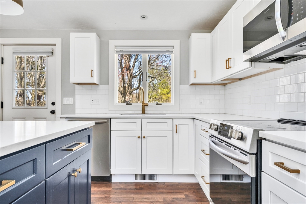 151 Wheeler Street Rehoboth, MA 02769 - Photo 15 of 36 a kitchen with white cabinets and appliances
