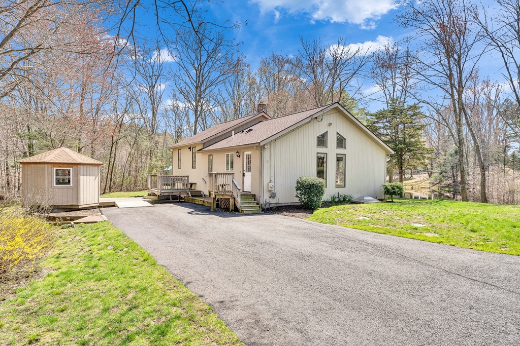 151 Wheeler Street Rehoboth, MA 02769 - Photo 2 of 36 a view of a house with a yard and large tree
