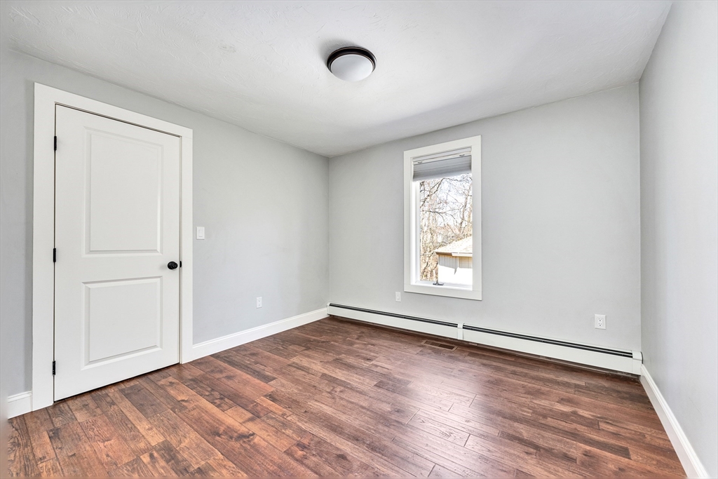 151 Wheeler Street Rehoboth, MA 02769 - Photo 22 of 36 a view of an empty room with wooden floor and a window