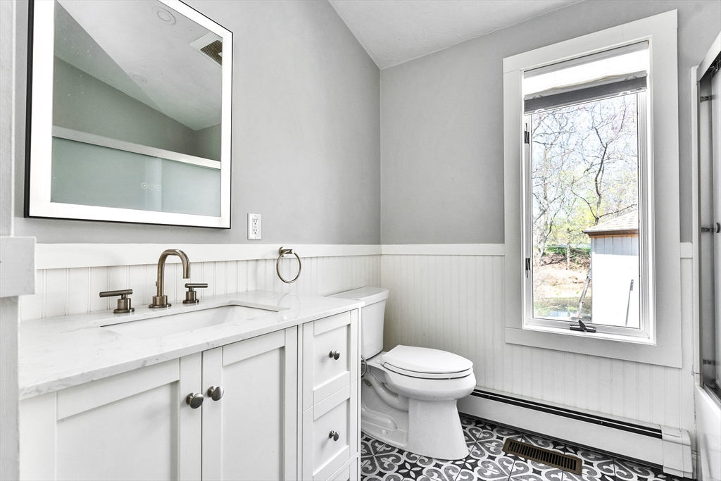 151 Wheeler Street Rehoboth, MA 02769 - Photo 24 of 36 a bathroom with a toilet a sink a vanity and mirror