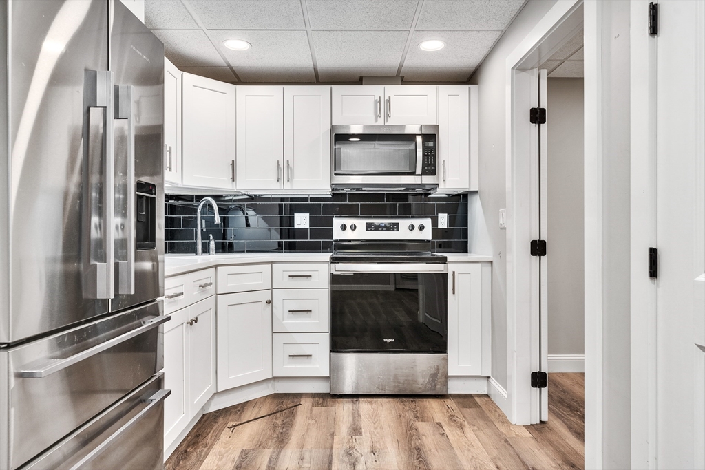 151 Wheeler Street Rehoboth, MA 02769 - Photo 31 of 36 a kitchen with stainless steel appliances a stove microwave and cabinets