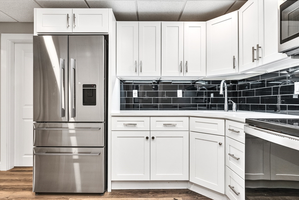 151 Wheeler Street Rehoboth, MA 02769 - Photo 32 of 36 a kitchen with white cabinets and white stainless steel appliances